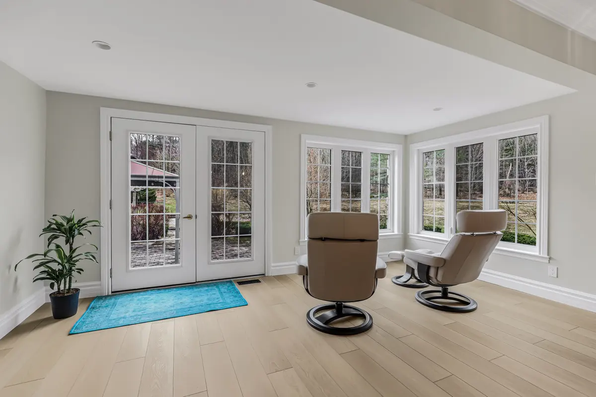 Completed flooring and trim in a bright living and dining room